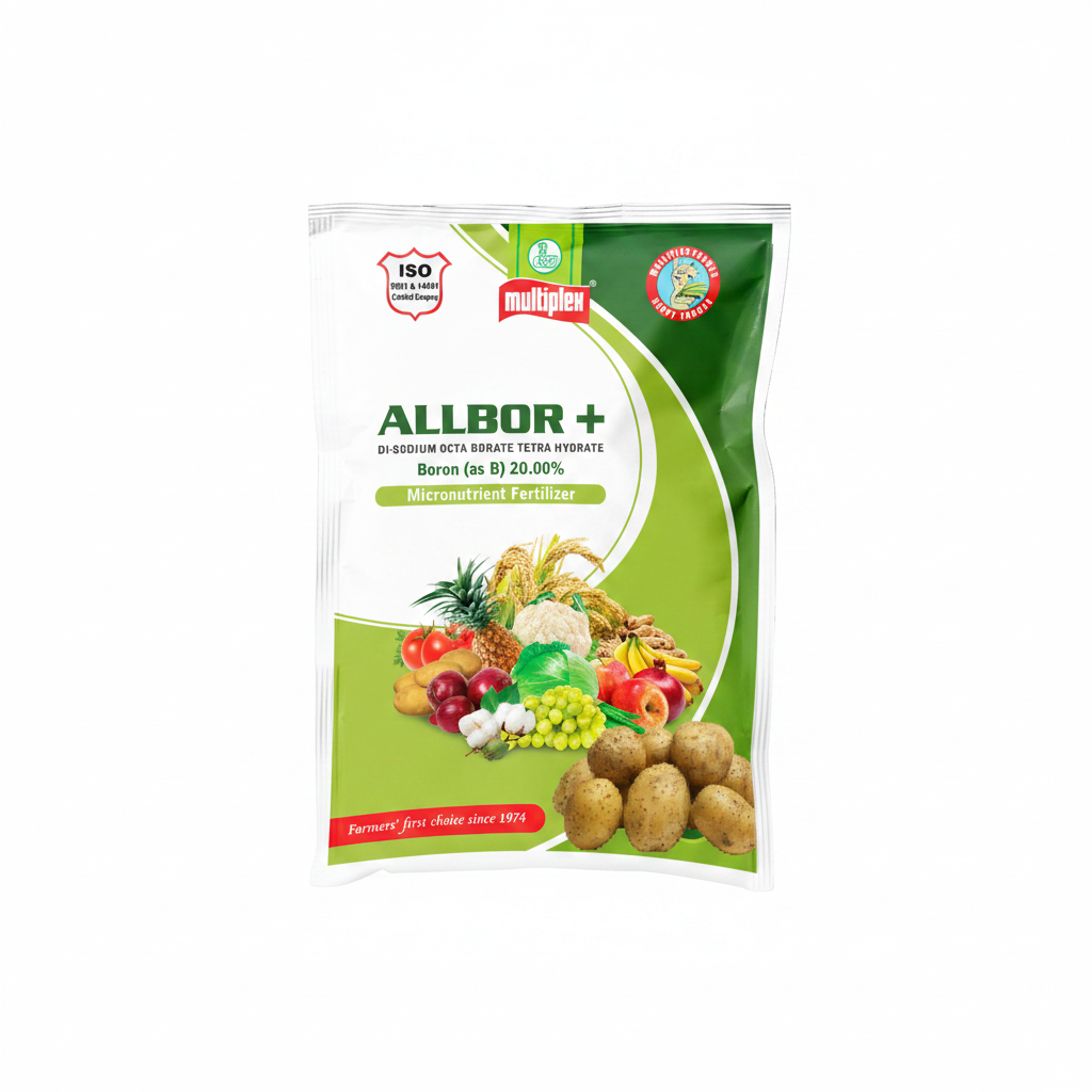 A bag of MultiPlex Allbor + Micronutrient Fertilizer is displayed on a wooden surface with an assortment of fresh fruits and vegetables, set against a blurred background of a field under a blue sky.
