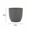 A large gray ribbed planter pot displayed on a small wooden stool against a plain light beige background.