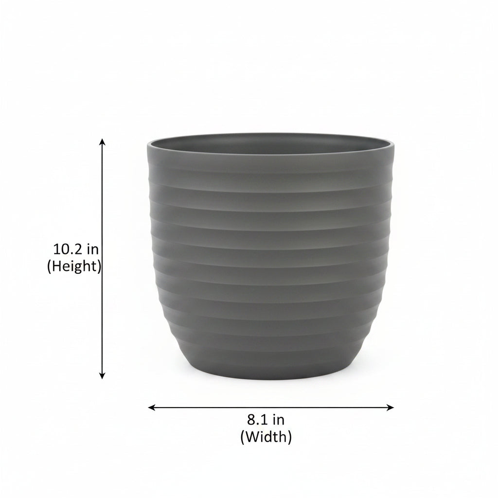 A large gray ribbed planter pot displayed on a small wooden stool against a plain light beige background.