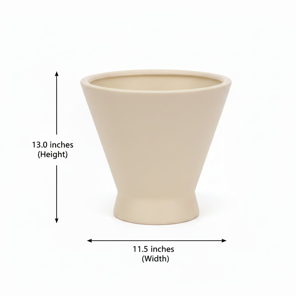 A beige ceramic planter pot with a white barcode label on the front, displayed on a dark wooden surface against a plain light gray wall.